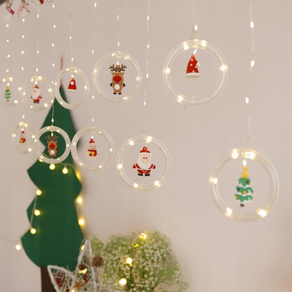 Kalėdinės užuolaidinės LED lemputės su vitražiniais personažais – Kalėdų Senelis, sniego seniai ir eglutės (108 LED, 3 m)